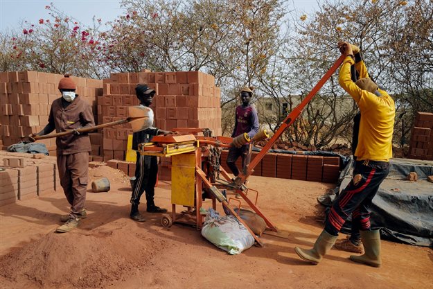 Workers make bricks with manual press at the Elementerre factory in Mbour. Reuters/Zohra Bensemra