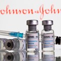 Vials labelled "Covid-19 coronavirus vaccine" and syringe are seen in front of displayed Johnson & Johnson logo in this illustration taken, February 9, 2021. Reuters/Dado Ruvic/File Photo