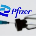 Syringe and vial are seen in front of displayed new Pfizer logo in this illustration taken, 24 June 2021. Reuters/Dado Ruvic/Illustration