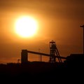 The sun sets behind a shaft outside the mining town of Carletonville, west of Johannesburg, file. Reuters/Siphiwe Sibeko