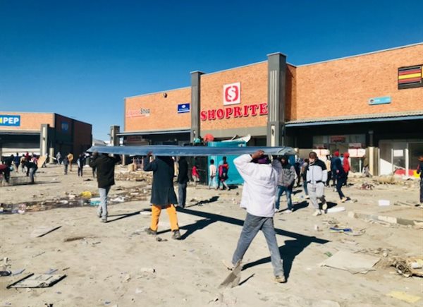 Looters carry off building materials at Tsakane Square.