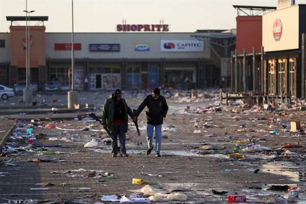 Members of a private security walk at a looted shopping mall in Vosloorus. Source: Reuters/Siphiwe Sibeko