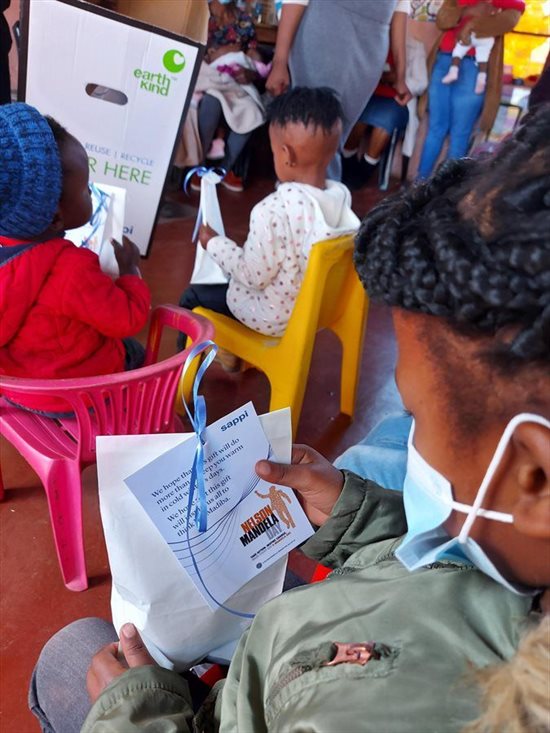 Kid with Sappi Mandela Day goodie bag