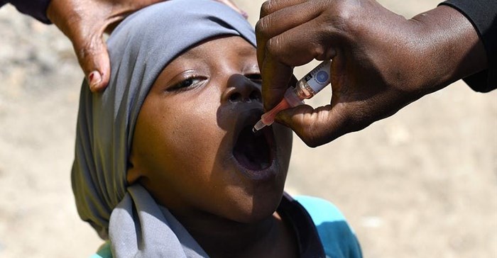 A child gets a dose of the oral polio vaccine. Simon Maina/AFP via Getty Images