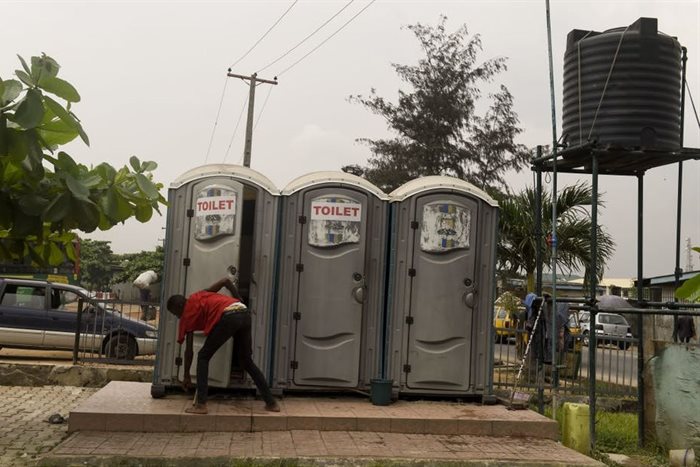 A boy leaves a mobile and portable public toilet at Ketu in Lagos. | Source: AFP via Getty Images/Pius Utomi Ekpei