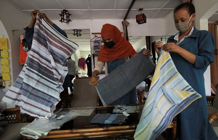 Employees of the Sammy Ethiopia hand made garments, hand-woven textiles and basketry factory package scarfs for export to US clients, at the factory in Addis Ababa, Ethiopia, 14 October 2021. Reuters/Tiksa Negeri