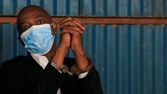 Nicholas Mwendwa, President of the Football Kenya Federation (FKF), reacts as he displays his handcuffs at the dock after arriving at the Milimani Law Courts in Nairobi, Kenya 15 November 2021. Reuters/Thomas Mukoya
