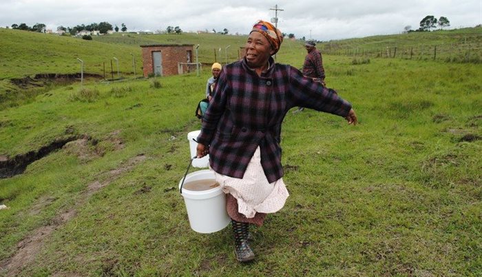 Nosebenzile Ntongolo, 64, lives in Mancam village in the Eastern Cape. She walks one kilometre from her house to a spring where she and other villagers collect water daily. | Photo: Mkhuseli Sizani