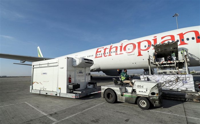 An Ethiopian Airlines staff unloads the AstraZeneca/Oxford vaccines under the COVAX scheme against the coronavirus disease (COVID-19) from a cargo plane at the Bole International Airport in Addis Ababa, Ethiopia March 7, 2021. REUTERS/Tiksa Negeri