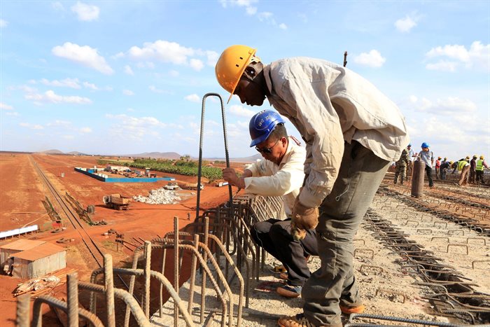 A Chinese engineer and a local construction worker work on a section of the Mombasa-Nairobi standard gauge railway (SGR) in Emali, Kenya. Reuters/Noor Khamis