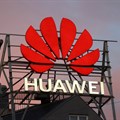 The logo of the Chinese telecommunications giant Huawei Technologies is pictured next to a statue on top of a building in Copenhagen, Denmark, 23 June 2021. Reuters/Wolfgang Rattay