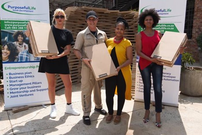 Representatives of The Cross Trainer, Jade Helene Shimmin and Nick Rheeder, handing over the Lenovo laptops to Nondumiso Dube and Sibongile Dladla. | Source: Supplied
