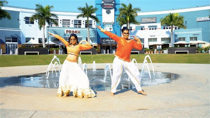 Image supplied: Jia Raghavjee and Priyen Naidoo perform outside at the Gateway Theatre of Shopping