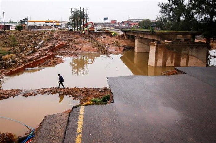A man walks around a damaged bridge caused by flooding in Umlazi near Durban. Reuters/Rogan Ward
