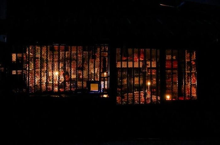 A shop owner waits for customers by candlelight during a power outage in Soweto. Reuters/Siphiwe Sibeko