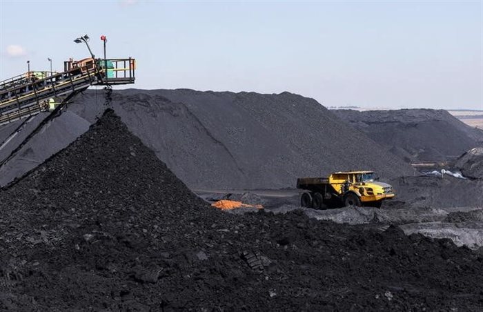 A truck drives past a conveyor pouring coal produced at Canyon Coal's Khanye colliery near Bronkhorstspruit, around 90km north-east of Johannesburg. Reuters/Siphiwe Sibeko