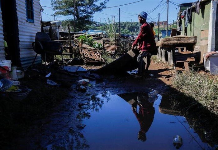 People drag a carpet into the sun to dry after their home was flooded in the Dakota informal settlement in Isipingo Beach, Durban. Reuters/Rogan Ward