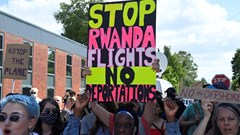 Image: Demonstrators protest outside of an airport perimeter fence against a planned deportation of asylum seekers from Britain to Rwanda, at Gatwick Airport near Crawley, Britain, 12 June 2022. Reuters/Toby Melville