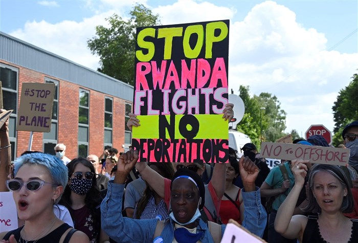 Image: Demonstrators protest outside of an airport perimeter fence against a planned deportation of asylum seekers from Britain to Rwanda, at Gatwick Airport near Crawley, Britain, 12 June 2022. Reuters/Toby Melville