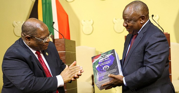 Source: Reuters. South Africa's President Cyril Ramaphosa receives the final investigation report from Chief Justice Raymond Zondo at the government's Union Buildings in Pretoria, South Africa, June 22, 2022.