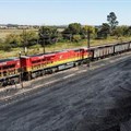 A Transnet Freight Rail train is seen next to tons of coal mined from the nearby Khanye Colliery mine, at the Bronkhorstspruit station, in Bronkhorstspruit, around 90 kilometres north-east of Johannesburg, South Africa, April 26, 2022. REUTERS/Siphiwe Sibeko