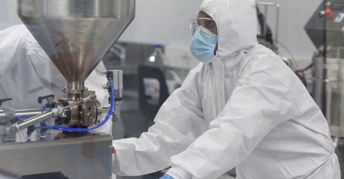 Source: Reuters/Shelley Christians. A production scientist works with samples at the Afrigen Biologics' site in Cape Town.