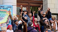 Members of the Goringhaicona and others opposing the River Club development celebrate the dismissal of an urgent application to depose Tauriq Jenkins (centre) as supreme high commissioner of the Goringhaicona Khoi Khoin Indigenous Traditional Council. Together with the Observatory Civic Association, the council has led litigation against the development. Photo: Steve Kretzmann / GroundUp