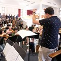 Image supplied: Russell Scott conducts an ad-hoc orchestra made up of professional musicians and youthful performers