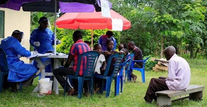 Source: Reuters. Ugandan health workers speak to members of the community before carrying out the first vaccination exercise against the ebola virus in Kirembo village.