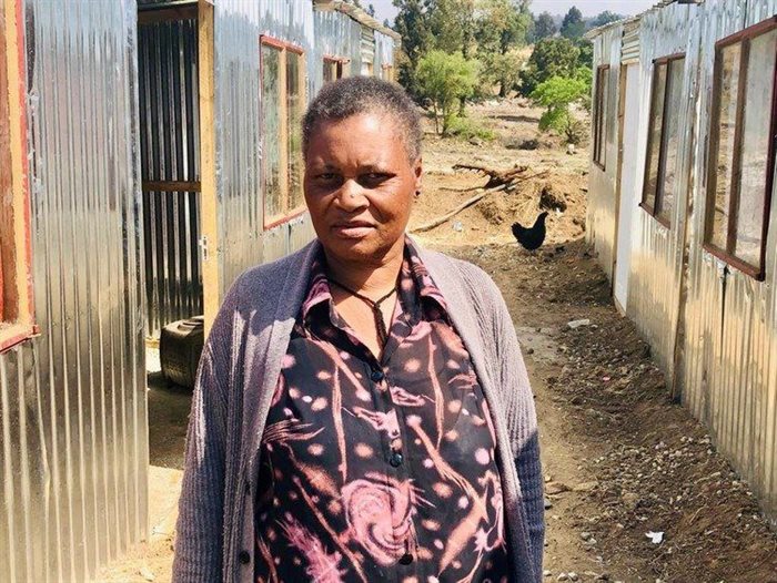 Maria Kwapeng, long-time resident of Tilly’s farm, who arrived with her three-year-old daughter, Merium, in 1982, standing in a lane between temporary shelters built by a property company on court orders. Photos: Kimberly Mutandiro