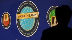 Image: A man is silhouetted against the logo of the World Bank at the main venue for the International Monetary Fund (IMF) and World Bank annual meeting in Tokyo, File. Reuters / Kim Kyung-Hoon