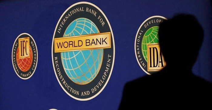 Image: A man is silhouetted against the logo of the World Bank at the main venue for the International Monetary Fund (IMF) and World Bank annual meeting in Tokyo, File. Reuters / Kim Kyung-Hoon