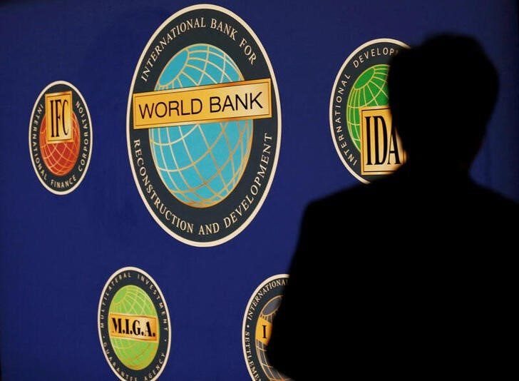 Image: A man is silhouetted against the logo of the World Bank at the main venue for the International Monetary Fund (IMF) and World Bank annual meeting in Tokyo, File. Reuters / Kim Kyung-Hoon