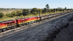 A Transnet Freight Rail train is seen next to tons of coal mined from the nearby Khanye Colliery mine, at the Bronkhorstspruit station, in Bronkhorstspruit, around 90km north-east of Johannesburg, South Africa, 26 April 2022. Reuters/Siphiwe Sibeko