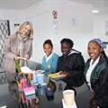Teacher Kathryn Couzens assists (left to right) Andrew-Lee Ninon, a grade eight learner at Axios School of Skills; Natalie Lange, a grade 12 learner at Gordon High School; Micaela Jackson, in grade 12 at Gordon High School; and Chanelle Jonkers, grade eight at Gordon High School.