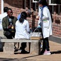 Source: Reuters. Zimbabwean medical workers sit outside Sally Mugabe Hospital during a strike by state doctors and nurses to press for higher pay, in Harare, Zimbabwe, June 20, 2022.