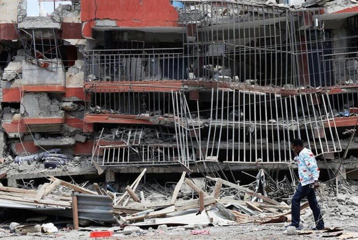 A man walks past the ruins of an apartment block that collapsed after 200 tenants were evacuated in Ruiru, on the outskirts of Nairobi, Kenya. Source: Reuters/Monicah Mwangi