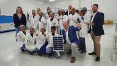 Supplied image: Alderman James Vos, Mayoral Committee Member for Economic Growth with employees of the company displaying an example of the solar panels manufactured.