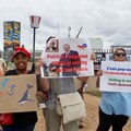 Members of Earthlife Africa and the Eastern Cape Environmental Network protested on Wednesday outside TotalEnergies service station in KwaDwesi, Gqeberha. Photo: Joseph Chirume/GroundUp
