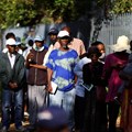 Social grant recipients stand in a queue outside a post office, as joblessness takes its toll in Meadowlands, a suburb of Soweto, South Africa, 24 February 2022. Reuters / Siphiwe Sibeko