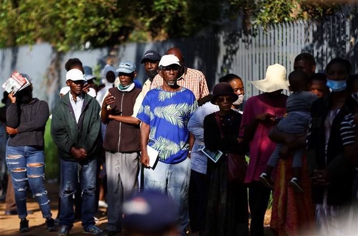 Social grant recipients stand in a queue outside a post office, as joblessness takes its toll in Meadowlands, a suburb of Soweto, South Africa, 24 February 2022. Reuters / Siphiwe Sibeko