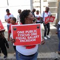 Members of the South African public sector union, National Education, Health and Allied Workers' Union (Nehawu) hold placards outside the Home Affairs office during a protest over wage disputes and other work issues in Cape Town, South Africa, 13 March 2023. Reuters/Esa Alexander