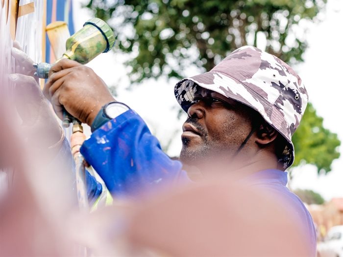Production artist on site preparing the artwork