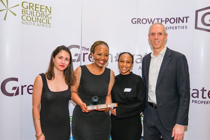 Georgina Smit, GBCSA head of technical, and Grahame Cruickshanks, Growthpoint head of sustainability and utilities, with last year's first prize winners in Property Greenovation, Toneka Pasiwe and Mbali Mahlangeni, University of Cape Town