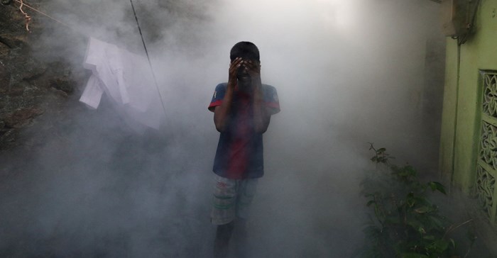 Source: Reuters.A boy covers his face from smoke as a health worker fumigates against mosquitoes in a residential area, as Sri Lanka tries to curb dengue fever across the island in Colombo, Sri Lanka 12 July, 2023.