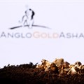 A small toy figure and gold imitation are seen in front of the AngloGold Ashanti logo in this illustration taken November 2021. Source: Reuters/Dado Ruvic