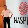 Bob van Dijk, CEO of e-commerce group Naspers, poses for a photograph in front of the company logo after holding a media briefing in Johannesburg. Source: Reuters/Siphiwe Sibeko