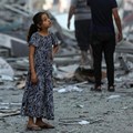 Source: Unicef/Mohammad Ajjour. Amal, 7 years old, contemplates her neighbourhood in the wake of the houses being levelled to the ground.