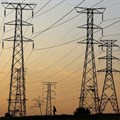 A man walks beneath electricity pylons during frequent power outages from South African utility Eskom, caused by its ageing coal-fired plants, in Orlando, Soweto. Source: Reuters/Siphiwe Sibeko