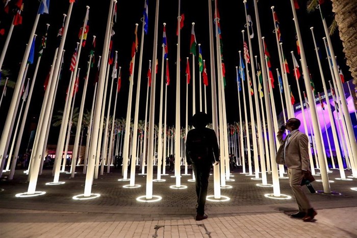 Image: Delegates stand near flag posts at the Dubai's Expo City after attending the World Climate Action Summit, during the United Nations Climate Change Conference (COP28) in Dubai, United Arab Emirates, 1 December 2023. Reuters/Thomas Mukoya./File Photo